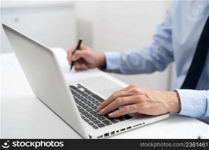 Business man working by using laptop computer Hands typing on a keyboard. Professional investor working new start up project. business planning in office. Technology business Concept.