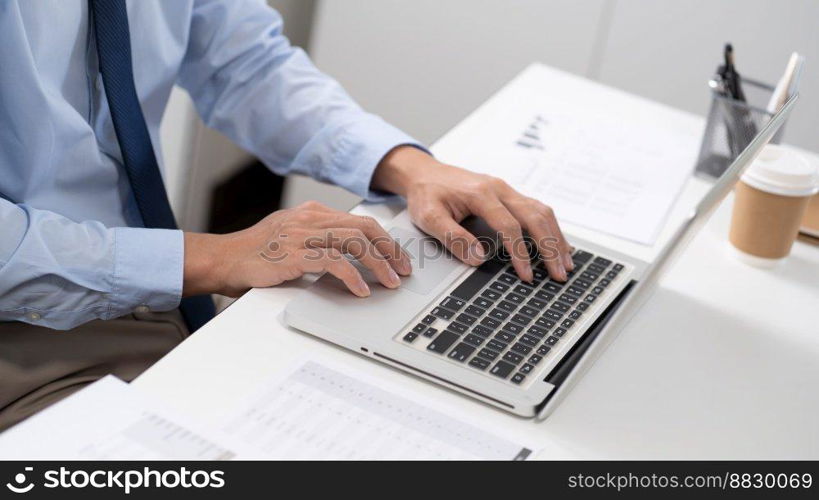 Business man working by using laptop computer Hands typing on a keyboard. Professional investor working new start up project. business planning in office. Technology business Concept. 