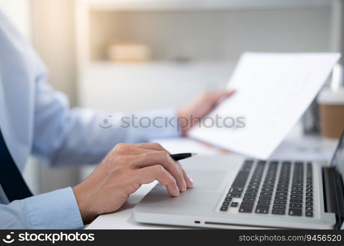 Business man working by using laptop computer Hands typing on a keyboard. Professional investor working new start up project. business planning in office. Technology business Concept. 