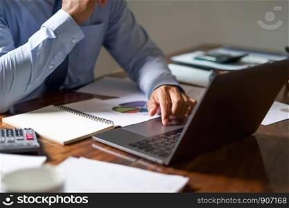 business man working check accounting report on laptop in office. finance account concept