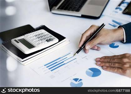 business man working in office with calculator and laptop