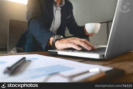 business man working on business document and laptop at a workplace