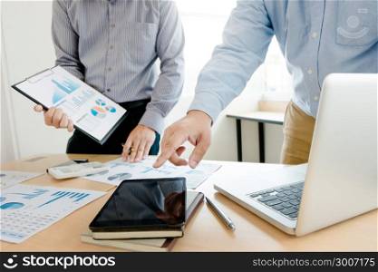 business man working on valuation documents, calculator and laptop at a workplace