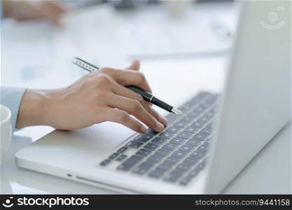 Business man working using laptop computer Hands typing keyboard. Professional investor working start up project. business planning in office. Technology business Concept. 