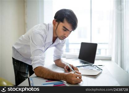 Business man working with laptop and documents on his desk.analyzing data in office