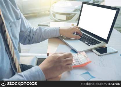 business man working with many document graph and laptop, calculator on his desk in morning light. business concept.