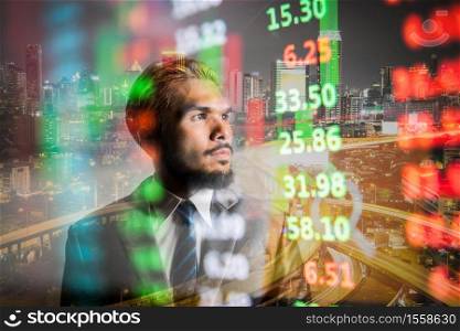 Business manwith modern visual technology for trading to sell in stock market with index graph and indicator background .