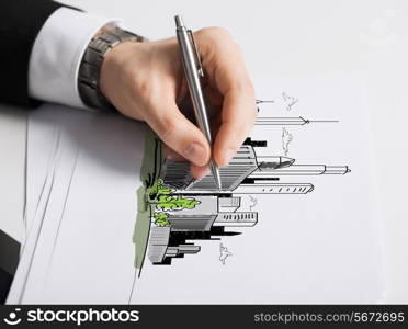 business, marketing, planning and people concept - close up of male hand with pen drawing city on white paper