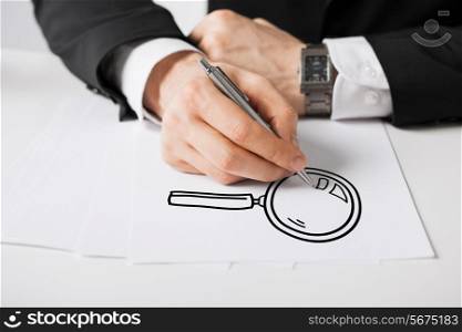 business, marketing, planning and people concept - close up of male hands with pen drawing lens on white paper