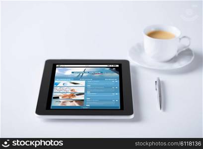 business, mass media, information and technology concept - tablet pc computer with world news web page on screen and cup of coffee