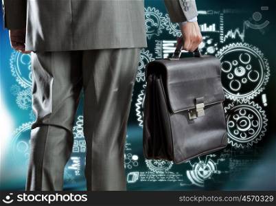 Business mechanisms. Rear view of businessman with suitcase and business sketches