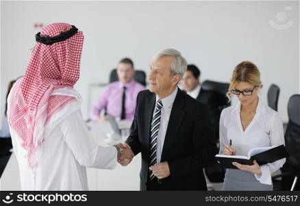 Business meeting - Handsome young Arabic man presenting his ideas to colleagues and listening for ideas for success investments at bright modern office room
