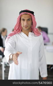 Business meeting - Handsome young Arabic man presenting his ideas to colleagues and listening for ideas for success investments at bright modern office room