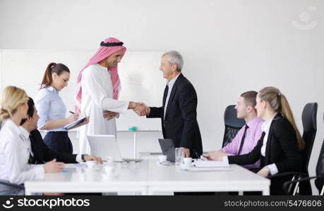 Business meeting - Handsome young Arabic man presenting his ideas to colleagues and listening for ideas for success investments at bright modern office room