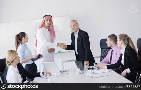 Business meeting - Handsome young Arabic man presenting his ideas to colleagues and listening for ideas for success investments at bright modern office room