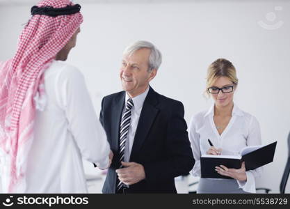 Business meeting - Handsome young Arabic man presenting his ideas to colleagues and listening for ideas for success investments at bright modern office room