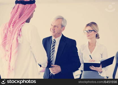 Business meeting - Handsome young Arabic man presenting his ideas to colleagues and listening for ideas for success investments at bright modern office room