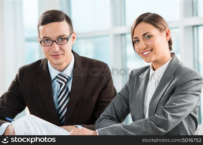 Business meeting in an office - two business people man and woman discussing their plans and reports