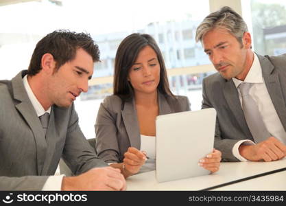 Business meeting with electronic tablet