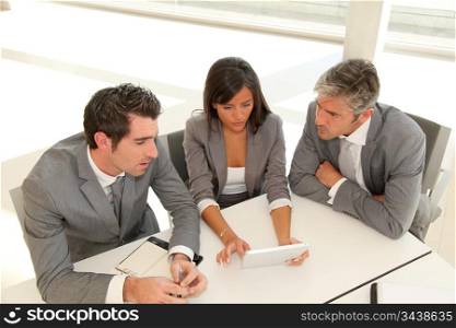 Business meeting with electronic tablet