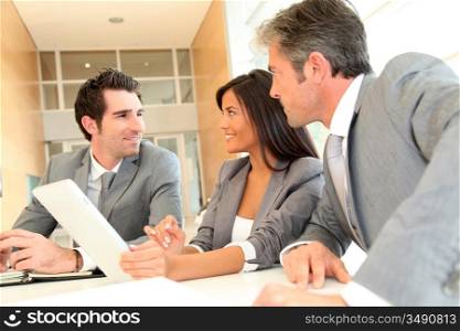 Business meeting with electronic tablet