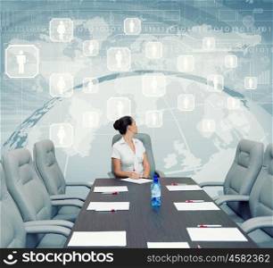 Business meeting. Young attractive businesswoman sitting at head of negotiating table