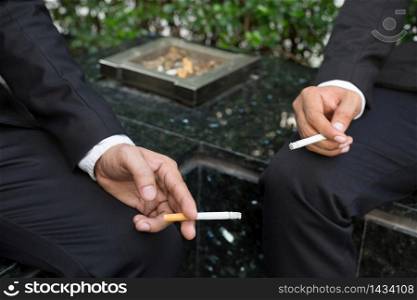 Business men are smoking outside