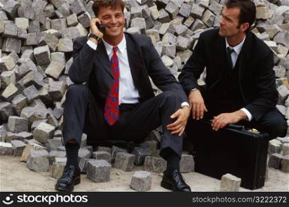 Business Men on Pile of Rocks
