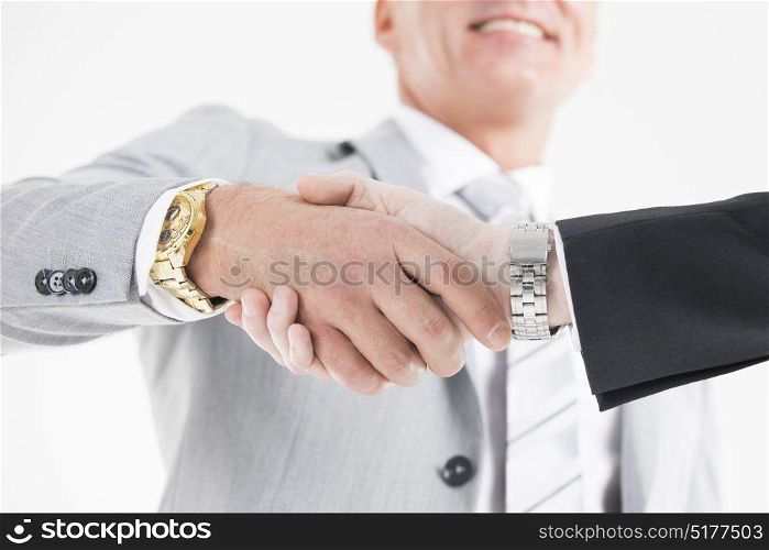Business men shaking hands. Confident business men shaking hands with each other. Close-up view of the hands of a businessman in formal wear