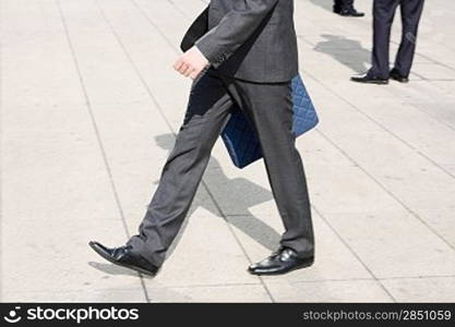 Business men walking on the pavement