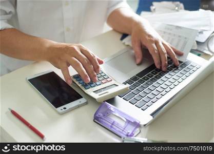 Business men work with calculator and laptop on the white table at office