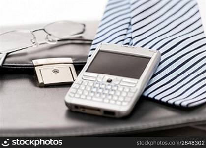 Business mens&acute; accessories tie briefcase phone on white background