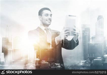 business, modern technology and communication concept - smiling businessman with tablet pc computer over city background and double exposure effect. smiling businessman with tablet pc computer