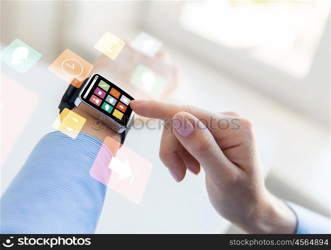 business, modern technology, media and people concept - close up of female hands setting smart watch with menu icons on screen at office