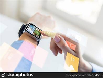 business, modern technology, media, internet and people concept - close up of female hands setting smart watch with news web page on screen at office