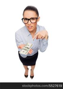 business, money and banking concept - smiling businesswoman in eyeglasses pointing finger to dollar cash money