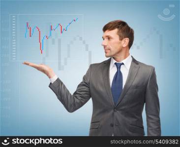 business, money and office concept - attractive buisnessman showing forex chart on the palm