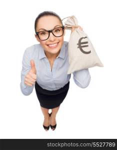 business, money and office concept - smiling businesswoman in eyeglasses holding money bag with euro and showing thumbs up