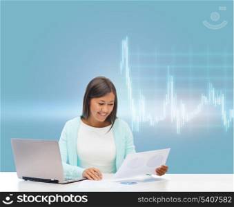 business, money and technology concept - asian businesswoman or student with laptop, forex chart and documents in office