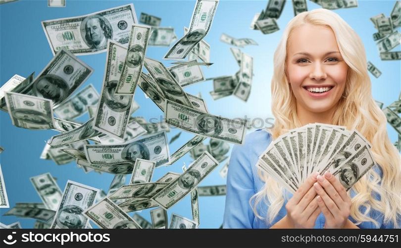 business, money, finance, people and banking concept - smiling businesswoman with dollar cash money over blue background