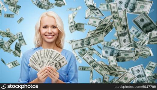 business, money, finance, people and banking concept - smiling businesswoman with dollar cash money over blue background