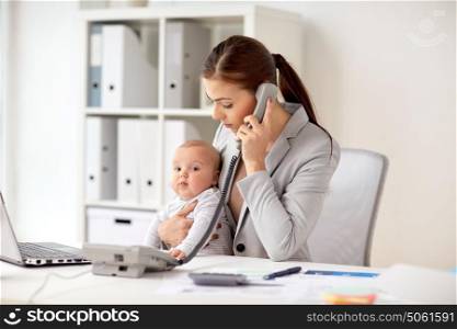 business, motherhood, multi-tasking, family and people concept - businesswoman with baby calling on phone at office. businesswoman with baby calling on phone at office