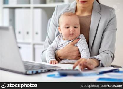 business, motherhood, multi-tasking, family and people concept - businesswoman with baby counting on calculator at office. businesswoman with baby working at office