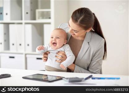 business, motherhood, multi-tasking, family and people concept - happy smiling businesswoman with baby working at office