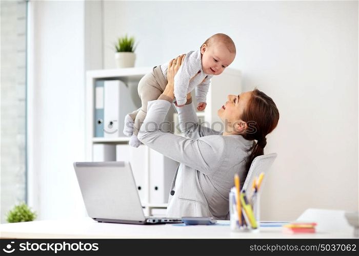 business, motherhood, multi-tasking, family and people concept - happy smiling businesswoman with baby and laptop computer working at office. happy businesswoman with baby and laptop at office