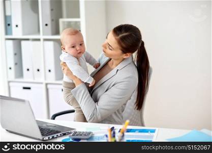 business, motherhood, multi-tasking, family and people concept - happy smiling businesswoman with baby and laptop computer working at office. happy businesswoman with baby and laptop at office