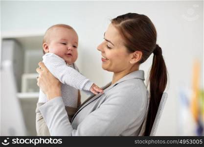 business, motherhood, multi-tasking, family and people concept - happy smiling businesswoman with baby at office. happy businesswoman with baby at office