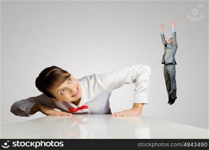 Business motivation. Funny image of businesswoman and miniature of businessman