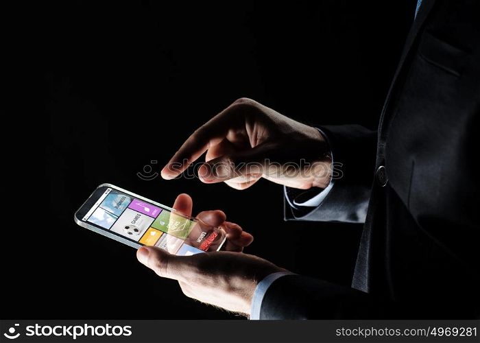 business, multimedia, people and future technology concept - close up of businessman hands with transparent smartphone with applications over black background. close up of businessman with apps on smartphone
