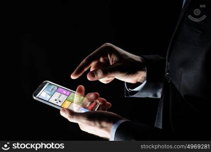 business, multimedia, people and future technology concept - close up of businessman hands with transparent smartphone with applications over black background. close up of businessman with apps on smartphone